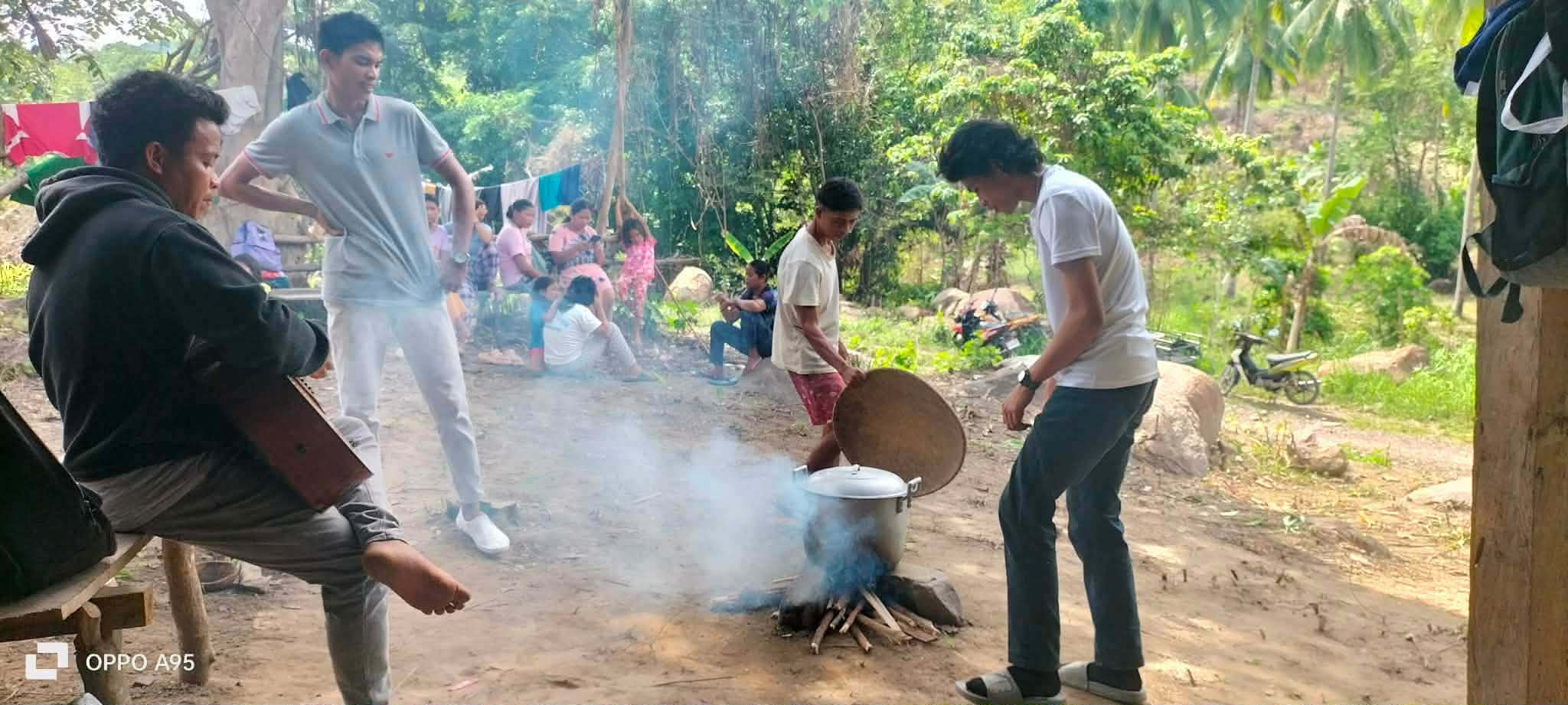 Preparing food outdoors during a community gathering