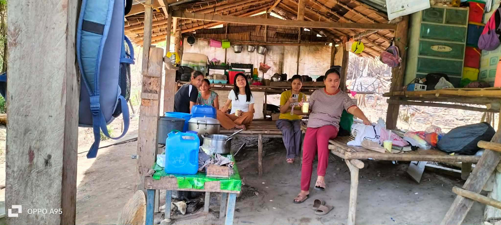 A family gathering beside a traditional rural home